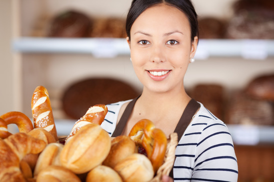 smiling salesgirl working in bakery